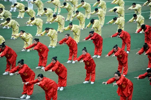 Students perform Wu Qin Xi, a type of qigong, during a competition in Bozhou, Anhui Province, China, April 20, 2016. (Photo by Reuters/Stringer)