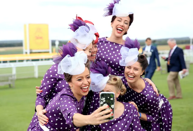 Racegoers pose for a selfie during day two of the Qatar Goodwood Festival at Goodwood Racecourse, Chichester on July 31, 2019. (Photo by Adam Davy/PA Images via Getty Images)