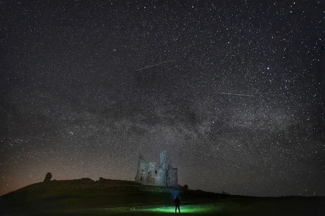 The Milky Way and millions of stars over Dunstanburgh Castle, Northumberland, England in the early hours of Thursday morning, April 11, 2019. (Photo by Owen Humphreys/PA Wire Press Association)