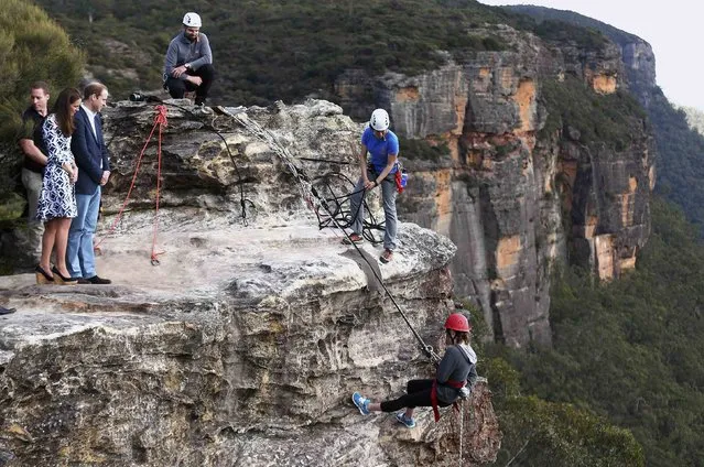 Britain’s Prince William watches rappelling by the Mountain Youth Services group with his wife, Catherine, the Duchess of Cambridge, at Narrow Neck Lookout in the Blue Mountains town of Katoomba, west of Sydney. The royal couple are undertaking a 19-day visit to New Zealand and Australia with their son, George. (Photo by Ryan Pierse/Reuters)