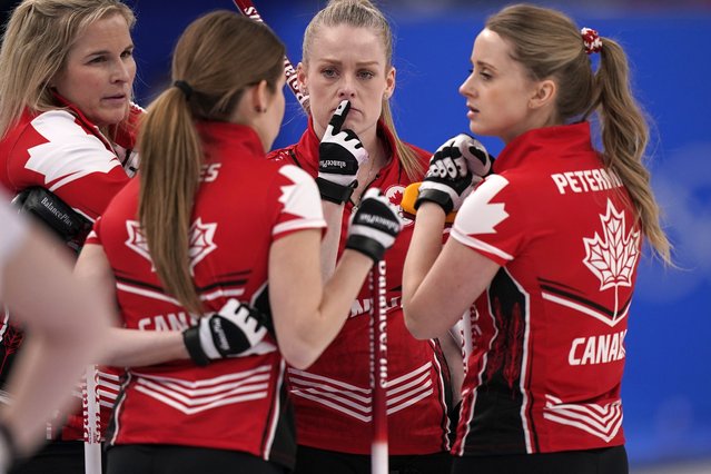 Team Canada talk between ends during a women's curling match against the Russian Olympic Committee at the Beijing Winter Olympics Monday, February 14, 2022, in Beijing. (Photo by Brynn Anderson/AP Photo)