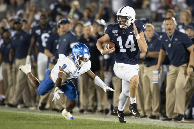 Penn State quarterback Sean Clifford (14) sprints away from Buffalo safety Joey Banks (9) on along gain during the third quarter of an NCAA college football game in State College, Pa., Saturday, September 7, 2019. (Photo by Barry Reeger/AP Photo)