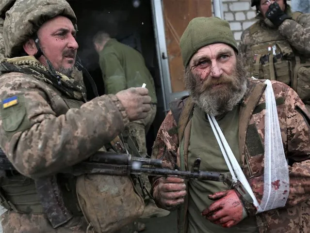 A wounded servicemen of Ukrainian Military Forces looks on after the battle with Russian troops and Russia-backed separatists in Lugansk region on March 8, 2022. The number of refugees flooding across Ukraine's borders to escape towns devastated by shelling and air strikes passed two million, in Europe's fastest-growing refugee crisis since World War II, according to the United Nations. (Photo by Anatolii Stepanov/AFP Photo)