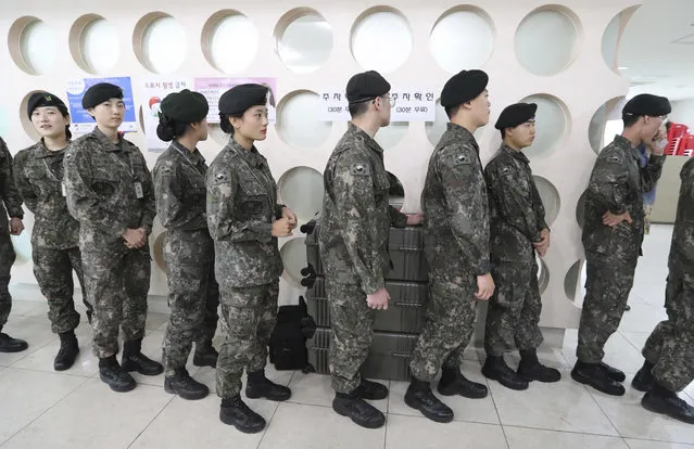 South Korean soldiers wait in line to cast for their votes for the May 9 presidential election at a local polling station in Seoul, South Korea, Thursday, May 4, 2017. South Korea's presidential election is scheduled for May 9, 2017. (Photo by Lee Jin-man/AP Photo)