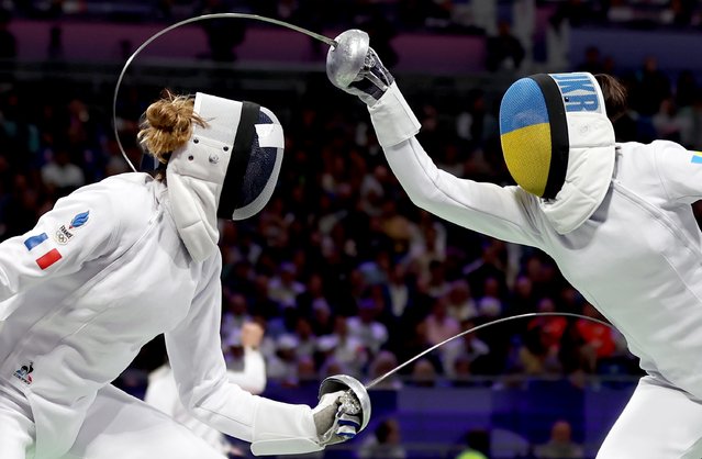 Auriane Mallo-Breton (L) of France in action against Vlada Kharkova of Ukraine in the Women Epee Individual Round of 8 in the Paris 2024 Olympic Games, at the Grand Palais in Paris, France, 27 July 2024. (Photo by Ritchie B. Tongo/EPA/EFE)