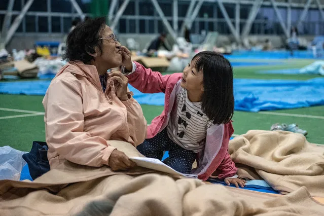 A grandmother and granddaughter play together in a refuge centre for people displaced by Typhoon Hagibis, on October 14, 2019 in Nagano, Japan. Japan has mobilised 110,000 rescuer workers after Typhoon Hagibis, the most powerful storm in decades, swept across the country leaving 37 dead and around 20 missing. (Photo by Carl Court/Getty Images)