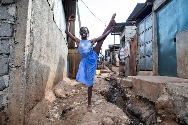 A ballet student from the Kibera based Project Elimu poses ahead of a public show in Kibera on August 14, 2024. Project Elimu, a community driven non profit organization, provides afterschool art, sport education programs for young people age 3 to 22. During school holidays the center holds street perfomances to encourage more students to join the dance center. Kibera is the largest slum in Nairobi, one of the largest in Africa. (Photo by Gordwin Odhiambo/AFP Photo)