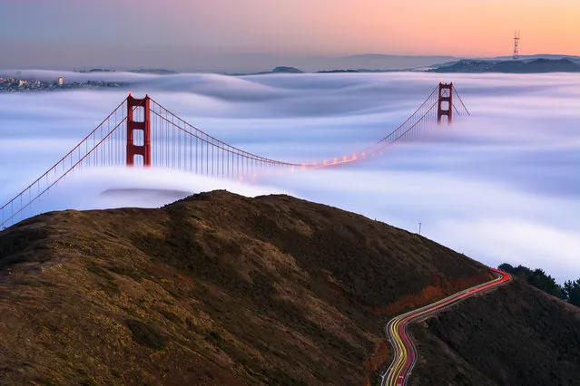“A Love Mysterious”. The sun sets as the majestic fog of the Pacific coast glides under the iconic Golden Gate Bridge. The long exposure of the fog reveals a silky texture as the low clouds rise and fall over San Francisco's trademark hills. All the while, tourists and locals alike make their drive along the mountainside, to try and capture the moment for themselves. Photo location: San Francisco, CA. (Photo and caption by Michael Perry/National Geographic Photo Contest)