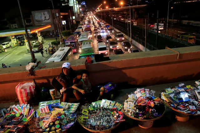 Vendors display their assorted items for sale at a sidewalk of a bridge where heavy traffic is seen on a busy road, in Metro Manila, Philippines December 23, 2016. (Photo by Romeo Ranoco/Reuters)