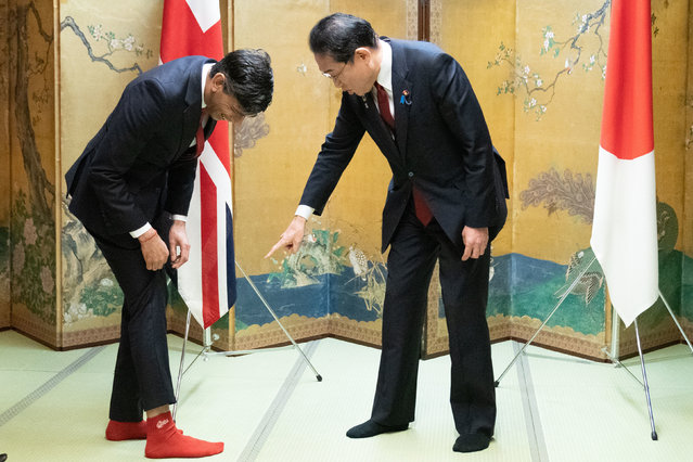 Prime Minister of the United Kingdom Rishi Sunak shows off his socks to Japanese Prime Minister Fumio Kishida, which has the name of Kishida's favorite baseball team, Hiroshima Toyo Carp, on them, during their bilateral meeting in Hiroshima ahead of the G7 Summit in Japan on Thursday, May 18, 2023. (Photo by Stefan Rousseau/PA Wire)