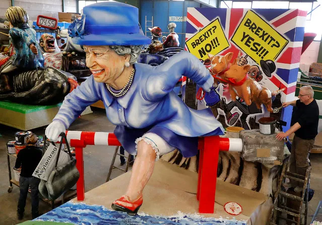 A paper mache figure depicting Queen Elizabeth running for asylum towards the EU is seen during the presentation of the floats for the upcoming Rose Monday parade in Mainz, Germany, February 26, 2019. (Photo by Kai Pfaffenbach/Reuters)