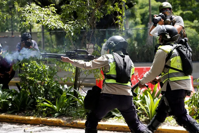 A riot police fires rubber bullets towards demonstrators during a protest called by university students against Venezuela's government in Caracas, Venezuela, June 9, 2016. (Photo by Carlos Garcia Rawlins/Reuters)