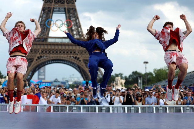 Men's synchronized 10m diving bronze medallists Rylan Wiens and Nathan Zsombor-Murray of Canada, jump during the medalists celebrations with women's synchronised 3m springboard silver medalist Kassidy Cook of the United States on August 1, 2024. (Photo by Hamad I Mohammed/Reuters)