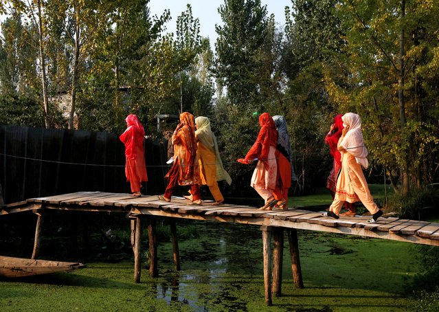 Kashmiri women walk to vote at a polling station, during the second phase of assembly elections, in Srinagar on September 25, 2024. (Photo by Sharafat Ali/Reuters)