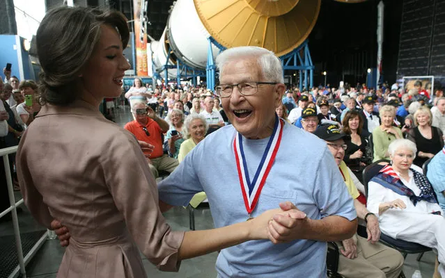 U.S. Army veteran Bob Sperl, from Decatur, Ala., dances with Anna Bailey who is wearing her grandmother's 1940's era dress, during the World War II 70th Anniversary Victory Day Commemoration inside the U.S. Space and Rocket Center's Davidson Center For Space Exploration Monday, August 10, 2015. More than 1,500 people attended the event which saw 450 veterans honored. (Photo by Gary Cosby Jr./The Decatur Daily via AP Photo)