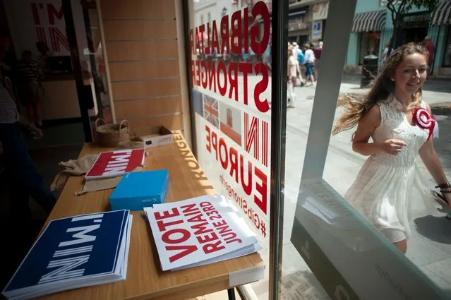 A woman passes by a Remain campaign office during the referendum on whether the United Kingdom should stay in or leave the European Union, in Gibraltar on June 23, 2016. The United Kingdom has gone to the polls to decide whether or not the country wishes to remain within the European Union. British, Irish and Commonwealth citizens over the age of 18 who live in Britain, as well as citizens of Gibraltar, are all eligible to vote provided they have registered. (Photo by Jorge Guerrero/AFP Photo)