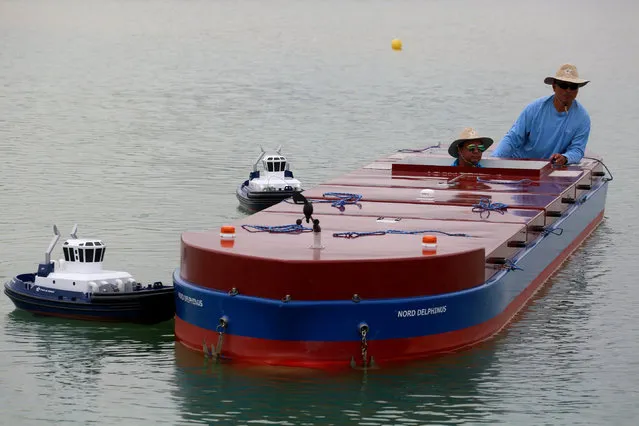 A Panama Canal pilot maneuvers a scale cargo boat during a training day at the scale model maneuvering training facility of the Panama Canal, a day before the inauguration of the Panama Canal Expansion project on the outskirts of Panama City, in Panama June 25, 2016. (Photo by Alberto Solis/Reuters)