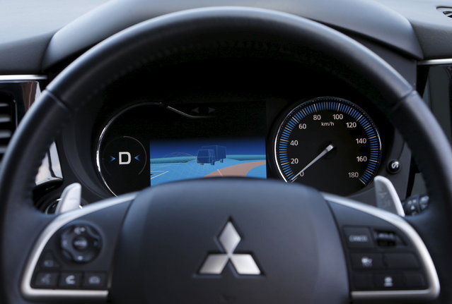 An onboard display monitor of Mitsubishi Electric's self-driving concept car “EMIRAI3 xAUTO” shows a risk map of a right turn collision by analyzing both front camera images and the database of traffic accidents in the past during a media preview in Kamakura, south of Tokyo, 2015. (Photo by Yuya Shino/Reuters)