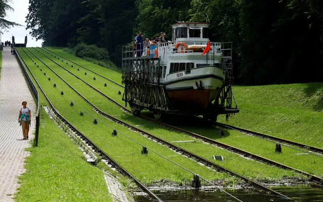 A ship rides on the tracks of the Buczyniec slipway on the Elblag Canal in Buczyniec, Poland August 10, 2017. (Photo by Kacper Pempel/Reuters)