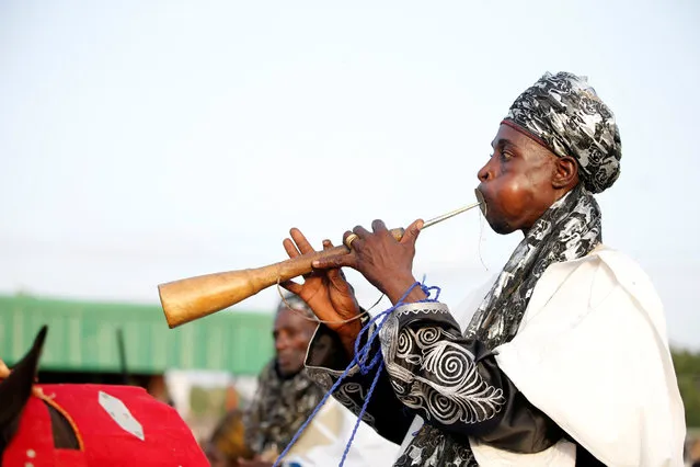 A traditional flutist performs during the durbar festival on the second day of Eid-al-Fitr celebrations in Nigeria's northern city of Kano, July 7, 2016. (Photo by Akintunde Akinleye/Reuters)