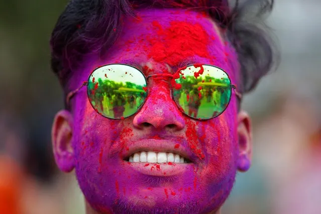 A student of Rabindra Bharati University daubed in colors looks on during Holi celebrations inside the university campus in Kolkata, India, March 5, 2020. (Photo by Rupak De Chowdhuri/Reuters)
