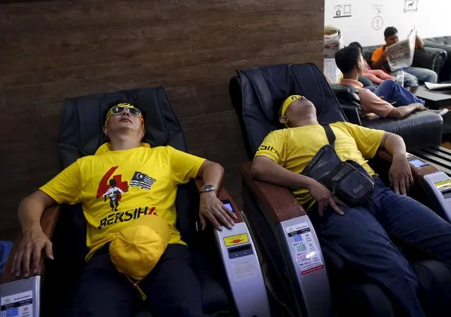 Supporters of pro-democracy group “Bersih” (Clean) sit in massage chairs as they rest at a hotel lobby after a morning of rallying in Malaysia's capital city of Kuala Lumpur August 30, 2015. (Photo by Edgar Su/Reuters)