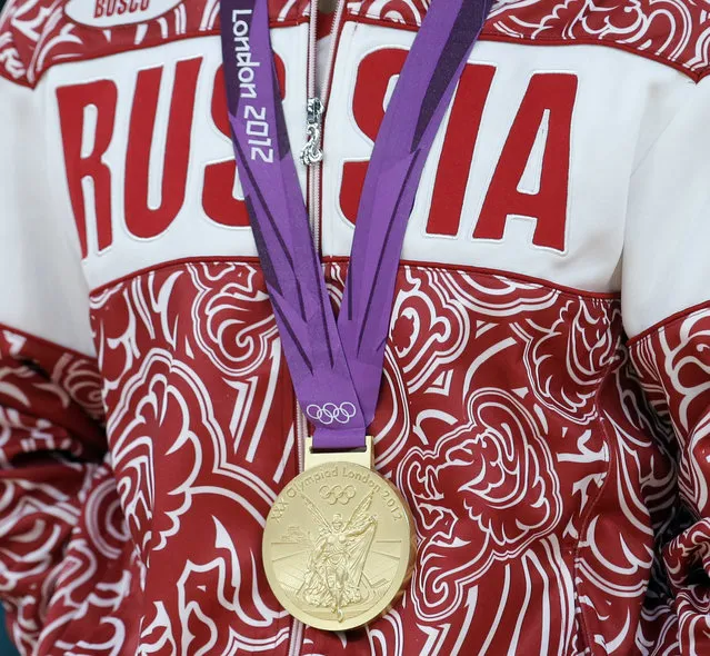 In this August 10, 2012 file photo a gold medalist from Russia participates in a medals ceremony at the 2012 Summer Olympics in London. The IOC's ruling 15-member executive board will meet Sunday, July 24, 2016 via teleconference to weigh the unprecedented step of excluding Russia as a whole from the 2016 Rio Olympic Games because of systematic, state-sponsored cheating. (Photo by Paul Sancya/AP Photo)