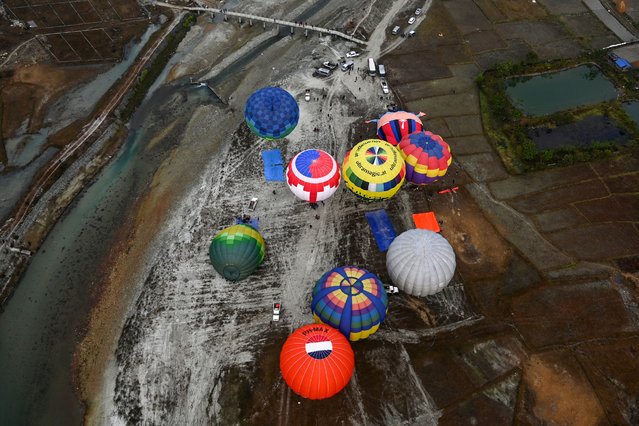 Hot air balloons rise in the sky during the International Hot-Air Balloon festival in Pokhara, Nepal on December 24, 2024. (Photo by Prakash Mathema/AFP Photo)