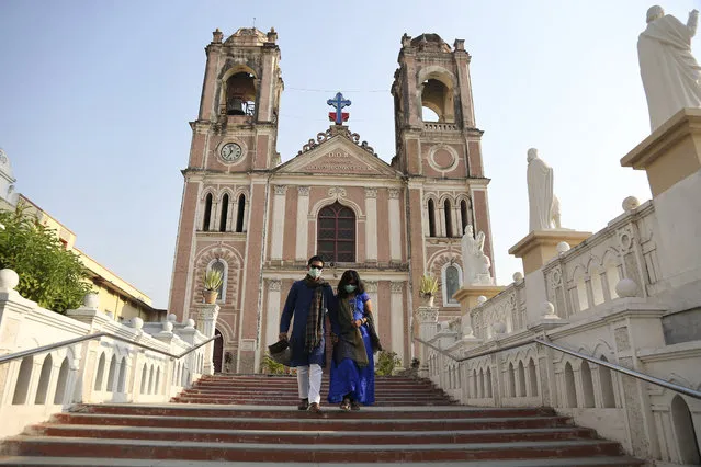 A couple walk back after visiting at a closed St. Joseph Cathedral on Easter in Hyderabad, India, Sunday, April 12, 2020. People around the world are celebrating Easter from the safety of their homes in an effort to help arrest the coronavirus outbreak. (Photo by Mahesh Kumar A./AP Photo)