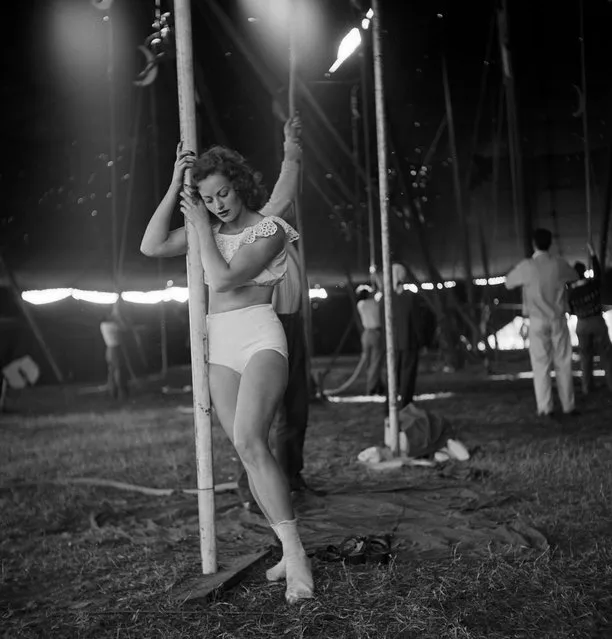 A circus girl standing near a pole while an unidentified man is holding a rope during a rehearsal for the Ringling Bros. and Barnum & Bailey Circus in Sarasota, FL in 1949. (Photo By Nina Leen/Time Life Pictures/Getty Images)