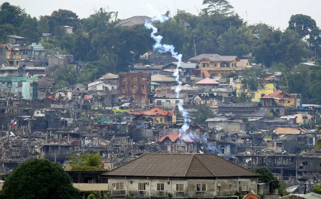 Teargas is fired by government troops as they continue their assault against the pro-Islamic State militant group during a clearing operation in Marawi city, southern Philippines, October 18, 2017. (Photo by Romeo Ranoco/Reuters)