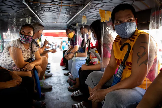 Passengers wearing protective masks sit between makeshift plastic barriers to maintain social distancing inside a jeepney amid the coronavirus disease (COVID-19) outbreak, in Angono, Rizal province, Philippines, June 3, 2020. (Photo by Eloisa Lopez/Reuters)