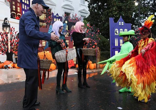U.S. President Joe Biden reacts to the costumes of visiting children as he and first lady Jill Biden distribute Halloween candy to children at the South Portico of the White House in Washington, U.S., October 31, 2022. (Photo by Leah Millis/Reuters)