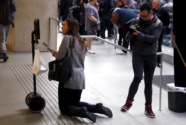 A radio journalist interviews Lucy Kelly on a screen attached to a 'telepresence robot' after Kelly purchased an iPhone 6s during the official launch at the Apple store in central Sydney, Australia, September 25, 2015. The new iPhone 6s and 6s Plus arrive in stores and at consumers' doorsteps on Friday, kicking off a sales cycle that will be scrutinized for signs of how much juice Apple's marquee product has left. (Photo by David Gray/Reuters)