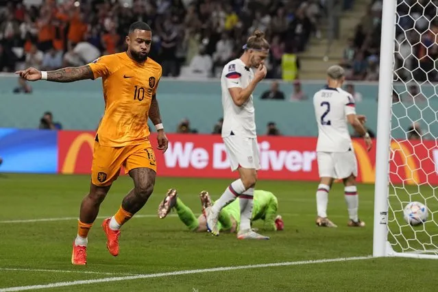 Memphis Depay of the Netherlands celebrates after scoring the opening goal of his team during the World Cup round of 16 soccer match between the Netherlands and the United States, at the Khalifa International Stadium in Doha, Qatar, Saturday, December 3, 2022. (Photo by Martin Meissner/AP Photo)