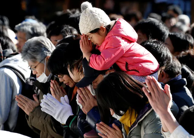 People offer prayers on the first day of the new year at the Meiji Shrine in Tokyo, Japan on January 1, 2018. (Photo by Toru Hanai/Reuters)