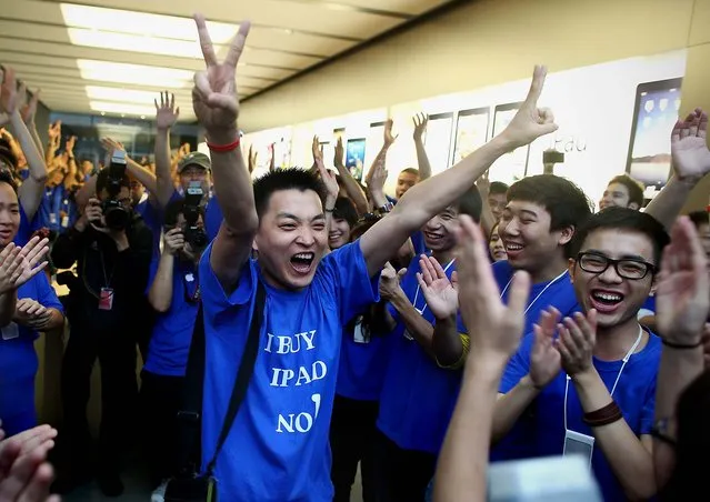 Han Ziwen celebrates his purchase of the first Apple iPad sold at the Apple store in Beijing. (Photo by ChinaFotoPress)