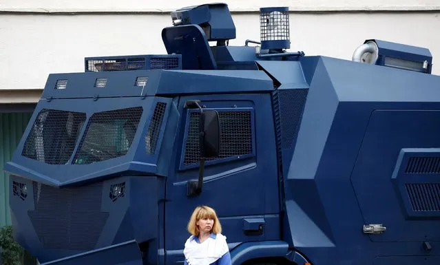 A woman is seen next to an armoured vehicle as people take part in a rally against presidential election results near the Ministry of Education in Minsk, Belarus August 25, 2020. (Photo by Vasily Fedosenko/Reuters)