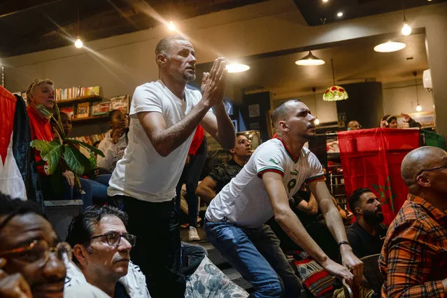 Moroccans and fans react as they watch in Johannesburg, South Africa, the World Cup semifinal soccer match between Morocco and France played in Qatar Wednesday, December 14, 2022. France won 2-0 and moved to the final. (Photo by Shiraaz Mohamed/AP Photo)