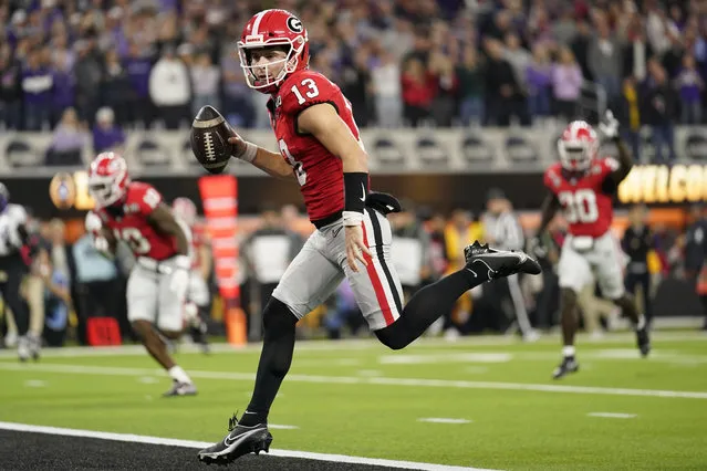 Georgia quarterback Stetson Bennett (13) runs into the end zone for a touchdown against TCU during the first half of the national championship NCAA College Football Playoff game, Monday, January 9, 2023, in Inglewood, Calif. (Photo by Ashley Landis/AP Photo)