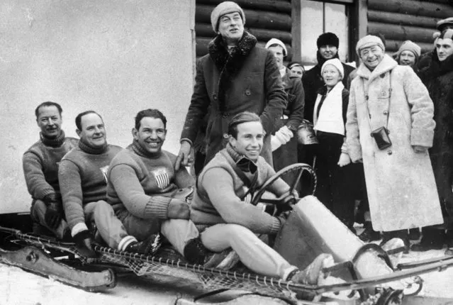 Full-length image of the four American athletes comprising the United States Olympic bobsled team, seated in their bobsled, with smiling onlookers, Lake Placid, New York, February 1932. The U.S. team won the Olympic title that year. (Photo by New York Times Co./Getty Images)