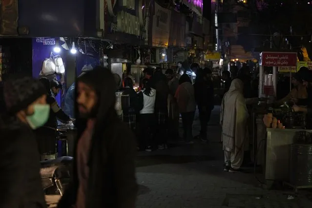 People visit a market, where some shopkeeper are using generators for electricity during a national-wide power breakdown, in Islamabad, Pakistan, Monday, January 23, 2023. (Photo by Anjum Naveed/AP Photo)