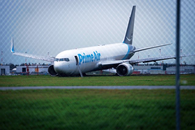 An Amazon Prime Air Boeing 767-338 sits on the grass after overrunning the runway, at the Vancouver International Airport in Richmond, British Columbia, Tuesday, November 19, 2024. (Photo byh Ethan Cairns/The Canadian Press via AP Photo)