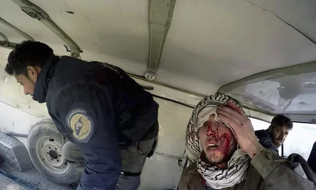This photo provided by the Syrian Civil Defense White Helmets, which has been authenticated based on its contents and other AP reporting, shows an injured man sitting inside a Civil Defense van after airstrikes hit near Ghouta, a rebel-held suburb near Damascus, Syria, Wednesday, February 28, 2018. The Syrian Observatory for Human Rights said the five-hour pause in eastern Ghouta was preceded by a barrage of airstrikes in the towns of Harasta and Douma, where Syrian troops and allied militia trying to push ahead with a ground offensive on a number of fronts from the east and west clashed with local insurgent groups. (Photo by Syrian Civil Defense White Helmets via AP Photo)