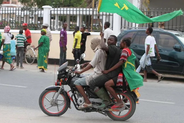 Supporters of Tanzania's ruling party Chama Cha Mapinduzi (CCM) presidential candidate John Magufuli celebrate after Magufuli was declared the winner in Dar es Salaam October 29, 2015. Magufuli, was declared the winner of the presidential election on Thursday, a result his main opposition rival rejected as rigged. The election has been the most hotly contested race in the more than half a century of rule by the CCM. (Photo by Reuters/Stringer)