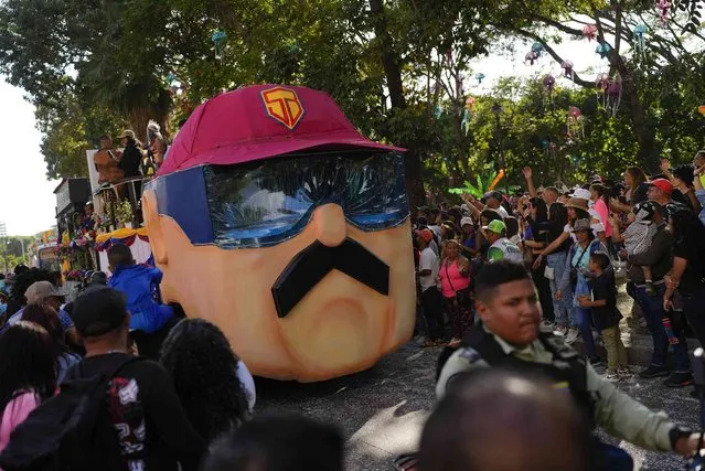 A carnival float depicting Super Mustache, or “Super Bigote” in Spanish, a character based on President Nicolas Maduro, parades during carnival celebrations in Caracas, Venezuela, Monday February 20, 2023. (Photo by Ariana Cubillos/AP Photo)