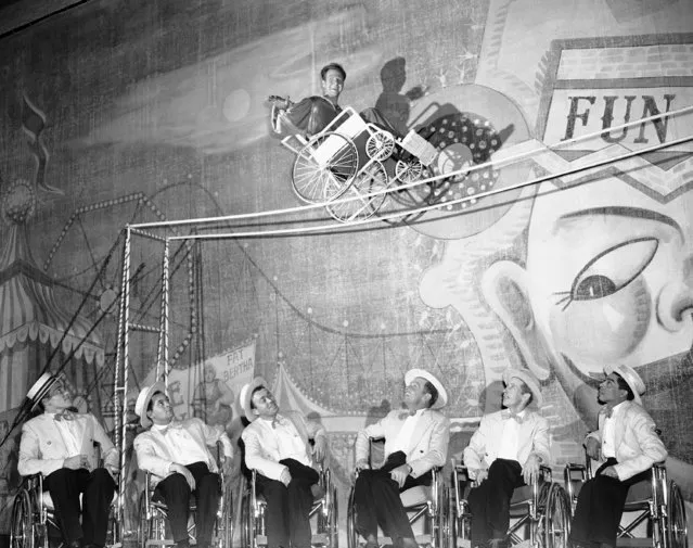 Eddie Teal, 24-year-old paraplegic from Oakland, Calif., practices his “tight rope” balancing act during rehearsal for the stage production of  “It's a Great Day” at Blackstone Theater in Chicago, Ill.,  February 7, 1951.  Eddie is one of 20 wheel chair vets in the cast of the musicals review which got its start nearly two years earlier at the Birmingham Veteran's hospital in Van Nuys, Calif, The Group raised $500.00 in 31 benefit performances for the March of Dimes and is now bidding for professional recognition. (Photo by Ed Maloney/AP Photo)