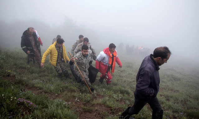 Iranian rescue workers carry the bodies of the victim of the crashed Iranian President helicopter, in the area of Varzaghan, Tabriz province, southwestern Iran, 20 May 2024. According to Iranian state media, President Raisi, Foreign Minister Hossein Amir-Abdollahian and several others were killed in a helicopter crash in the mountainous Varzaghan area on 19 May, during their return to Tehran, after an inauguration ceremony of the joint Iran-Azerbaijan constructed Qiz-Qalasi dam at the Aras river. Iran's first Vice President Mohammad Mokhber was appointed as the country's interim president following the death of Raisi, Iranian supreme leader Ayatollah Ali Khamenei announced in a condolence message on 20 May 2024. Mokhber will serve as caretaker president for a maximum period of 50 days before a presidential election must be held in Iran, the statement added. (Photo by Azin Haghighi/EPA/EFE)