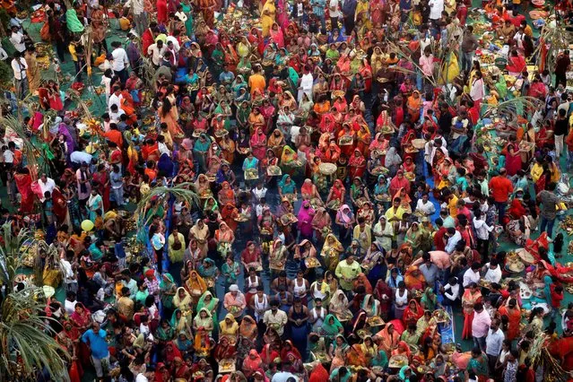 Hindu devotees worship the Sun god in an artificial pond during the religious festival of Chhath Puja, amid the spread of the coronavirus disease (COVID-19), in Mumbai, India, November 20, 2020. (Photo by Francis Mascarenhas/Reuters)