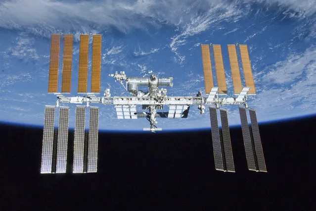 This photo provided by NASA shows the International Space Station as seen from the Space Shuttle Atlantis after the station and shuttle began their post-undocking relative separation on May 23, 2010. Twenty years after the first crew arrived, the space station has hosted 241 residents and grown from three cramped and humid rooms to a complex almost as long as a football field, with six sleeping compartments, three toilets, a domed lookout and three high-tech labs. (Photo by NASA via AP Photo)